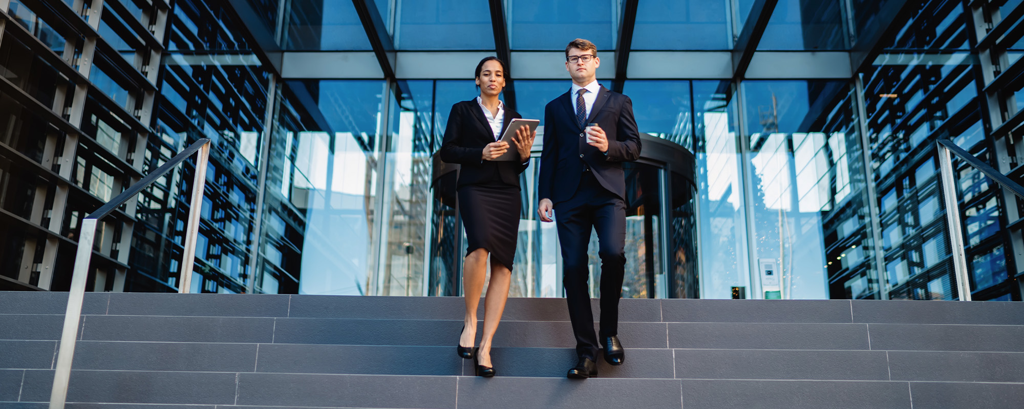 elegant young diverse colleagues on building steps