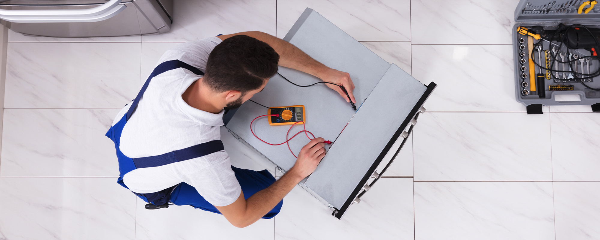 repairman working on dishwasher