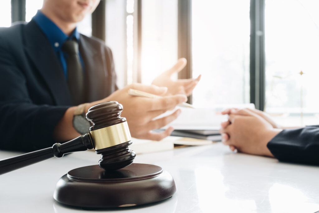 Business lawyer working about legal legislation in courtroom to help their customer, Selective Focus