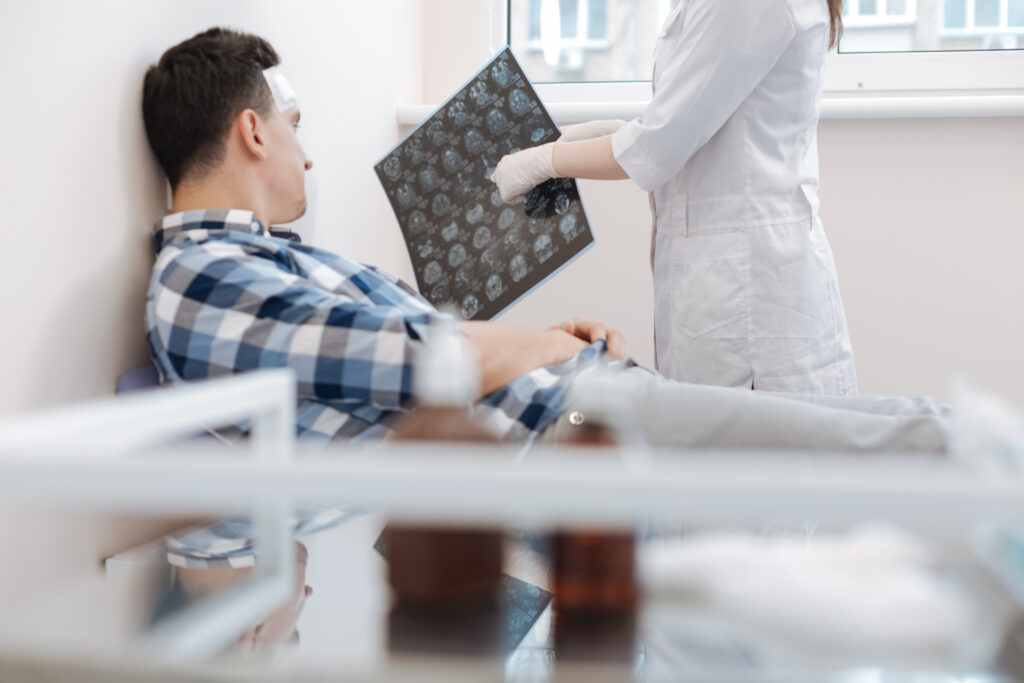 Nice professional doctor pointing at the X ray photo